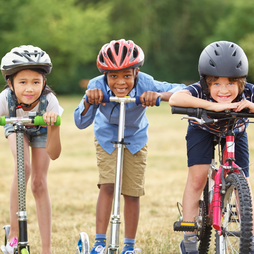 This is picture of three children wearing helmets.